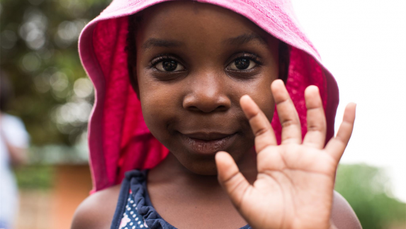 Young girl holding up her hand