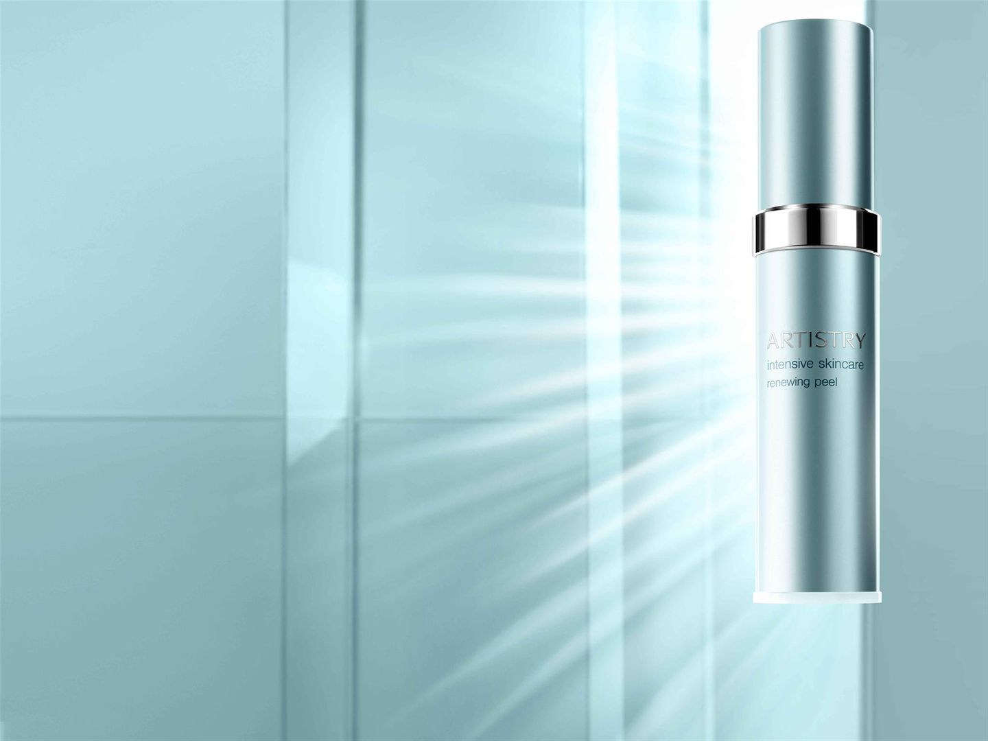 A bottle of Artistry Intensive Skincare Renewing Peel is backlit on a light teal background. This gentle at-home treatment features a naturally-derived mushroom enzyme that mimics the skin's natural exfoliation process, transforming skin's texture cell by cell.