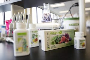 Packaged Nutrilite supplements on a counter in Amway's Research and Development lab. Supplement stability tests are conducted on every product and package, guaranteeing effectiveness and tablet shelf life through the expiration date listed on the package.