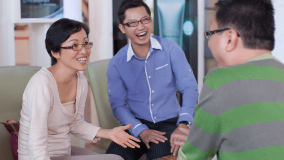 Three people talking and laughing