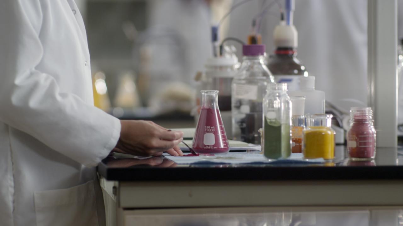 Lab worker working with different color powders