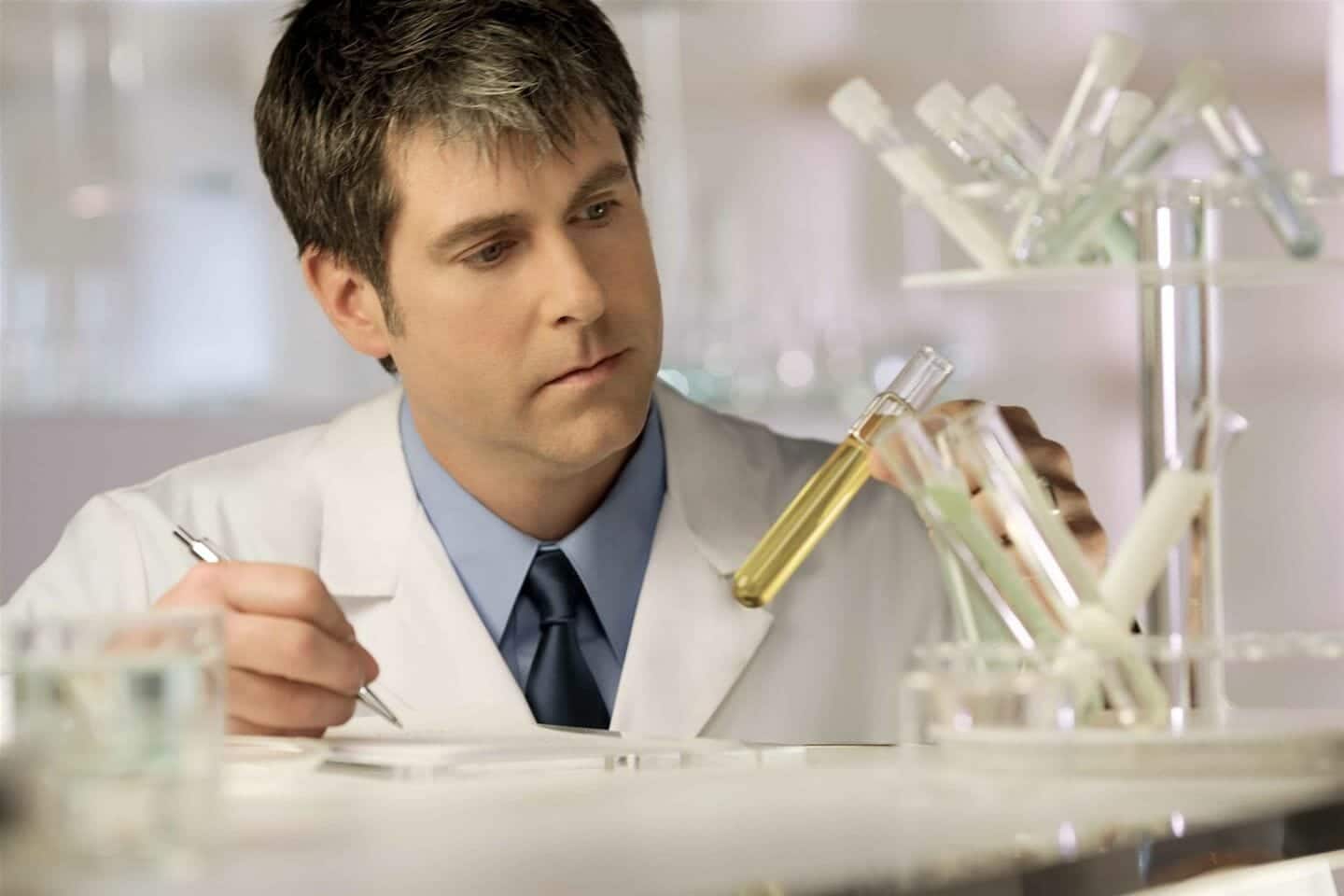Scientist examining fluid in test tube
