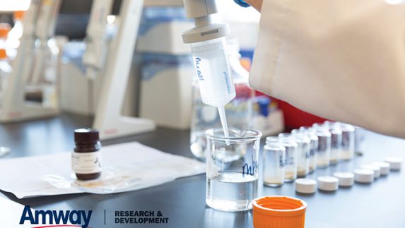 Lab worker using a syringe