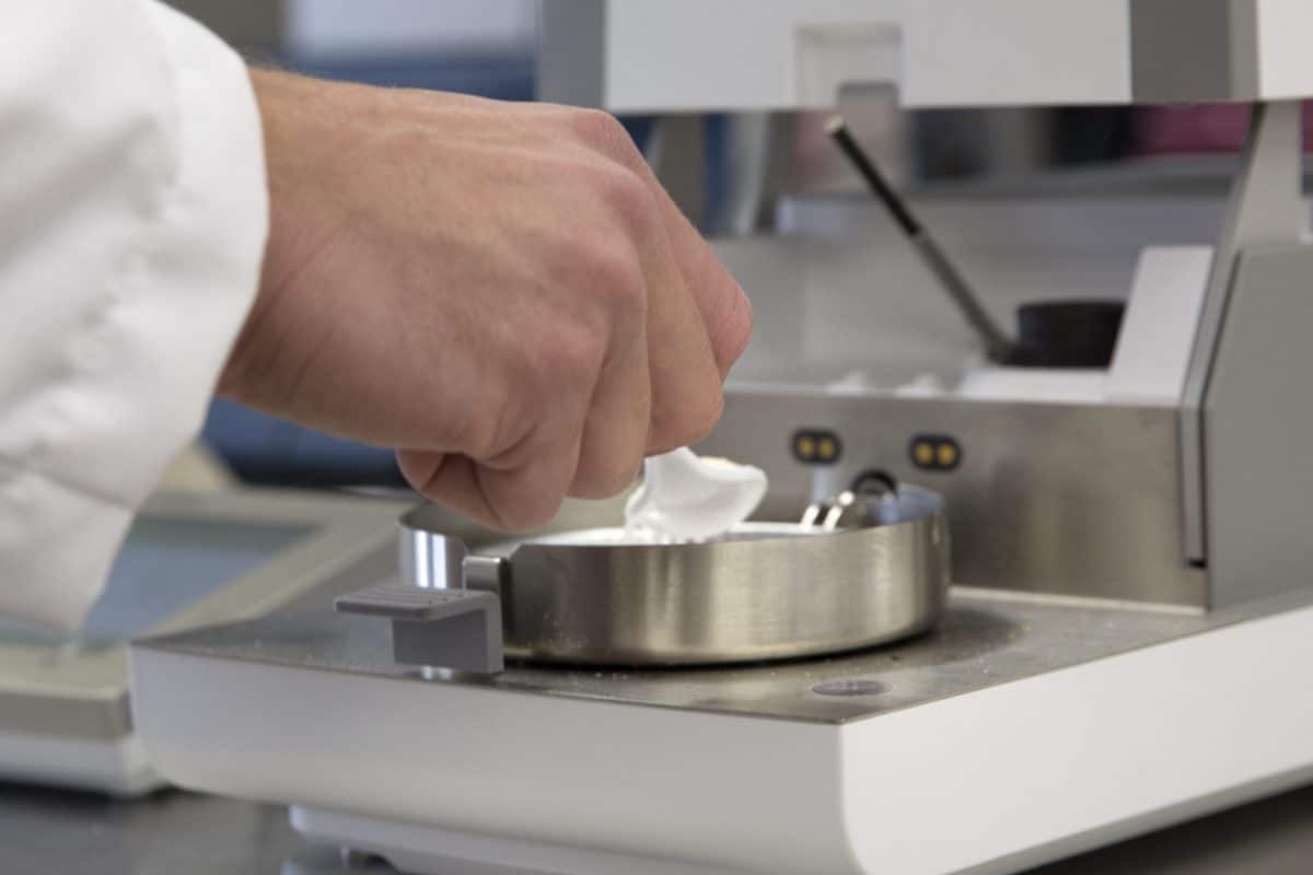 Scientist holding a spoon of powder