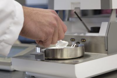 Scientist holding a spoon of powder