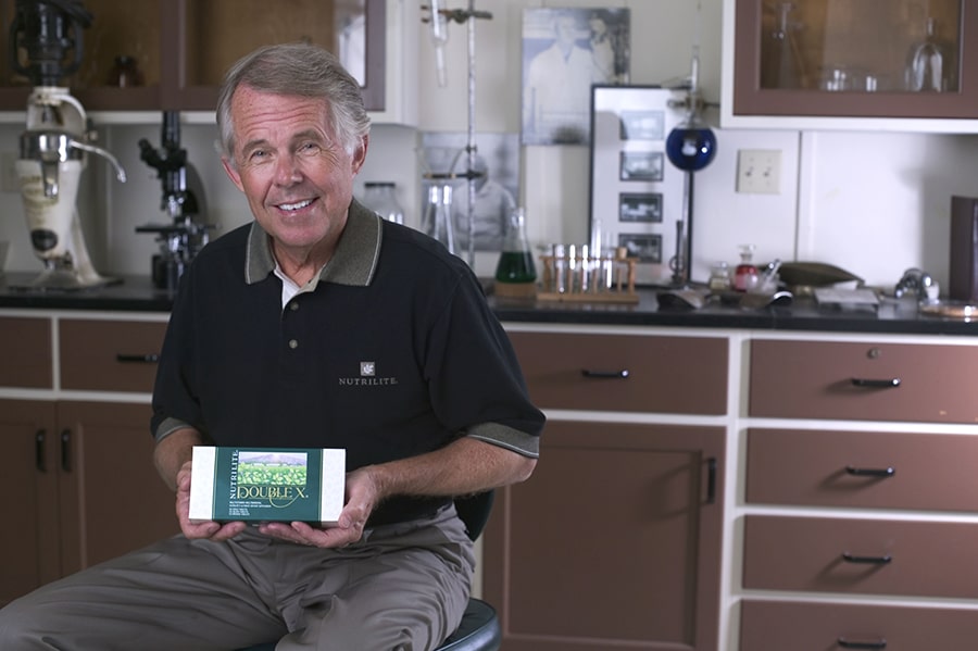 Nutrilite Double X Heritage Dr. Sam holding product