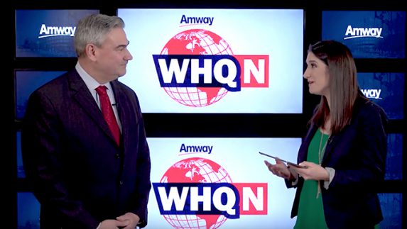 Amway COO Mike Cazer talks with Emily Richett about the company's quarterly business report at global headquarters in Ada, Michigan.