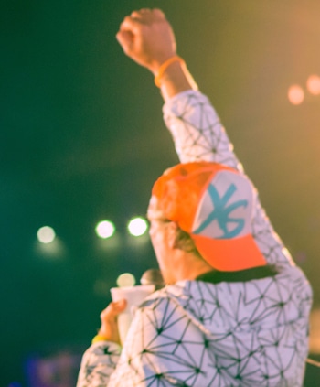 Man at concert wearing XS hat