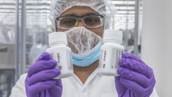 Nutrilite worker holding bottles of products