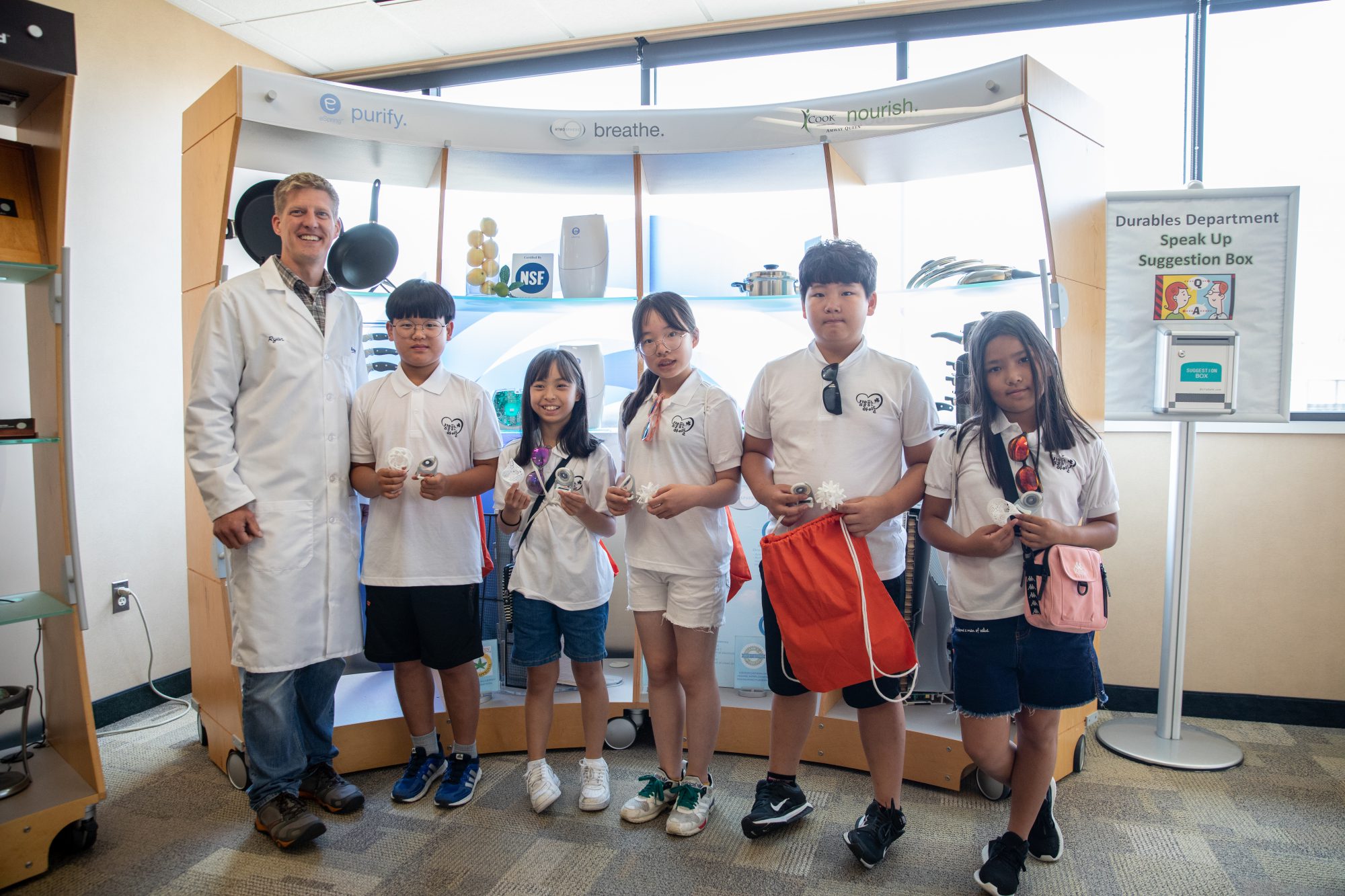 Worker standing with several students