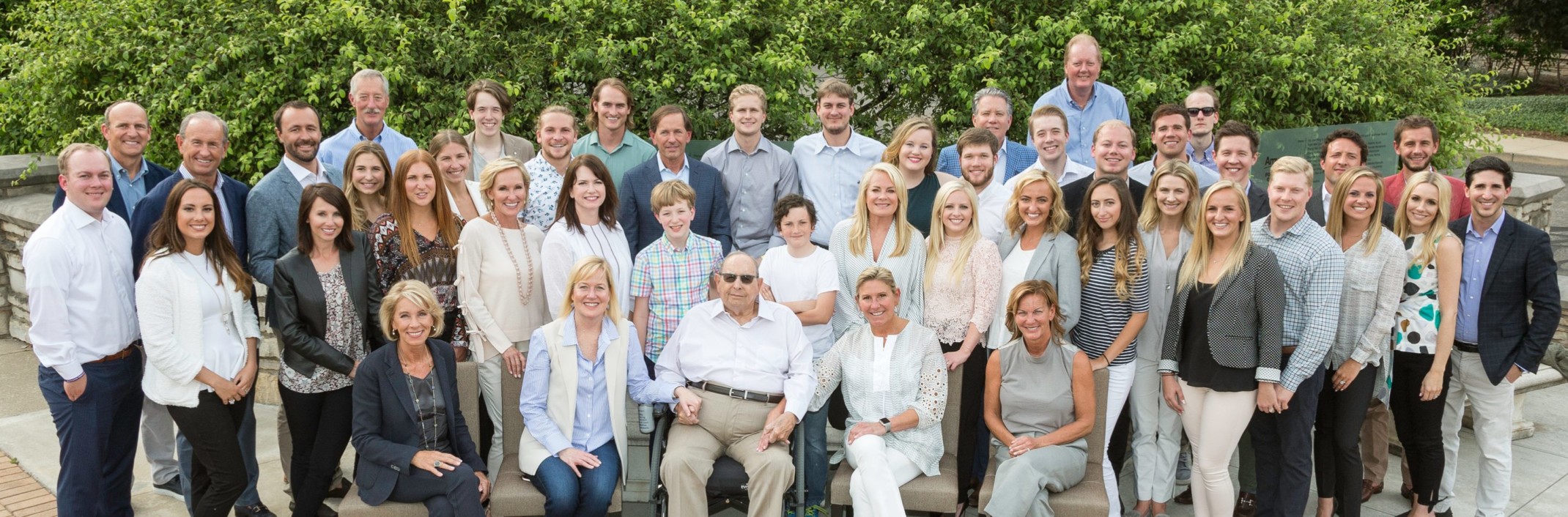 Multiple generations of the Amway's founding families flank Rich DeVos.