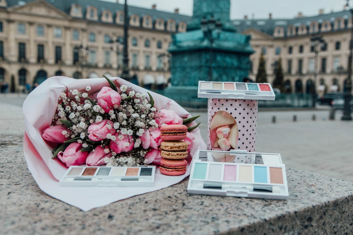 Artistry Studio Parisian Style Edition eye shadow compacts are posed with a bouquet of roses and baby's breath, a stack of macarons and a tin of sweets. Get the effortless "je ne sais quoi" of Parisian girls with our latest collection. Inspired by the style, art, and sweet treats of the City of Lights. Tres chic!