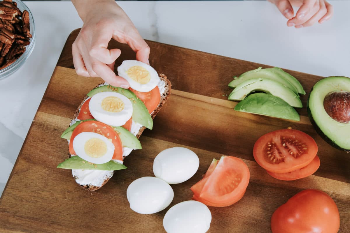 girl making avocado egg toast
