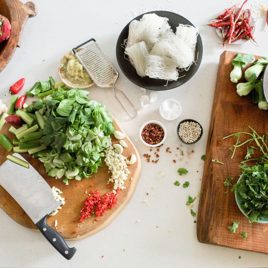 Two wood cutting boards with freshly chopped herbs and vegetables. Dishes arranged between the boards contain seasonings, dried peppers and rice noodles. You can cook with confidence knowing that Amway Home surface cleaning products are as safe as they are effective when used as directed. The Bioquest Formula technology delivers powerful cleaning and contains ingredients derived from natural sources. No dangerous fumes. No harmful residue. Powerfully green for a safer clean.