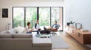 A cropped image of a family enjoying time together at home with the dog. An Atmosphere Sky air treatment system stands against the wall. The world-class Atmosphere Sky Air Treatment System is precision-crafted to remove the smallest impurities and the slightest odors – protecting families against pollutants invisible to the human eye, and providing the assurance of breathing cleaner air.