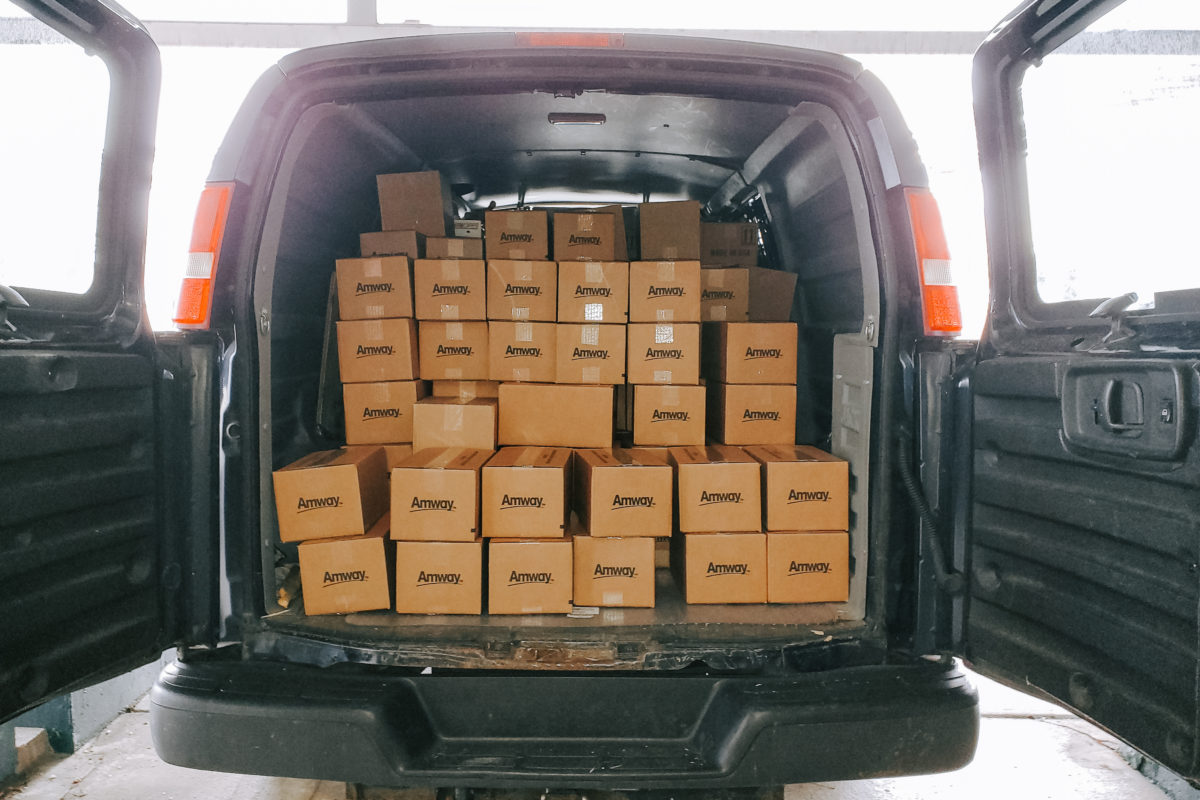 Amway boxes loaded into the back of a van