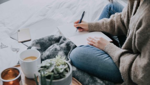 Woman writing in a journal