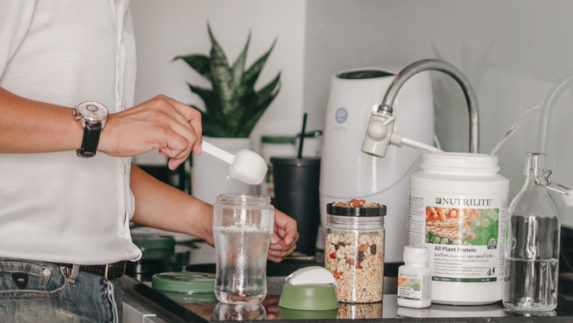 Man preparing a Nutrilite protein shake