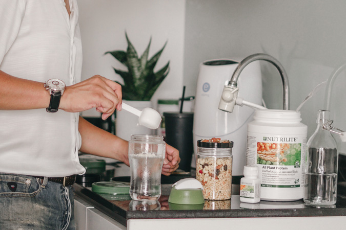 Man preparing a Nutrilite protein shake