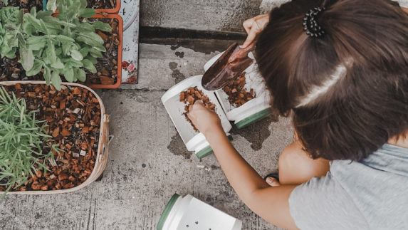 Woman tending to potted plants