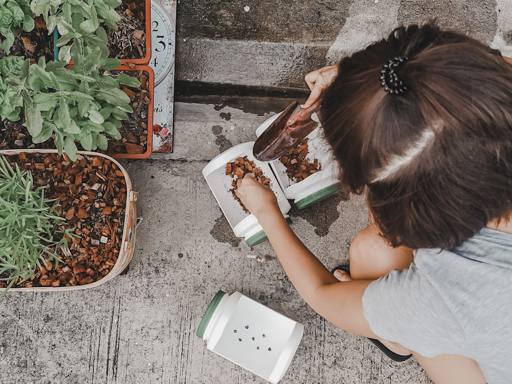 Woman tending to potted plants