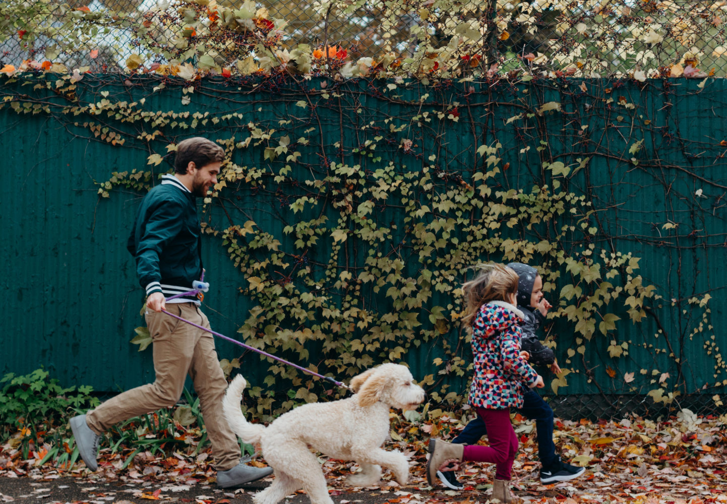 Man and children walking a dog