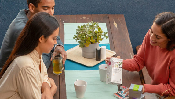 Amway Business Owners sitting at a table and showing product