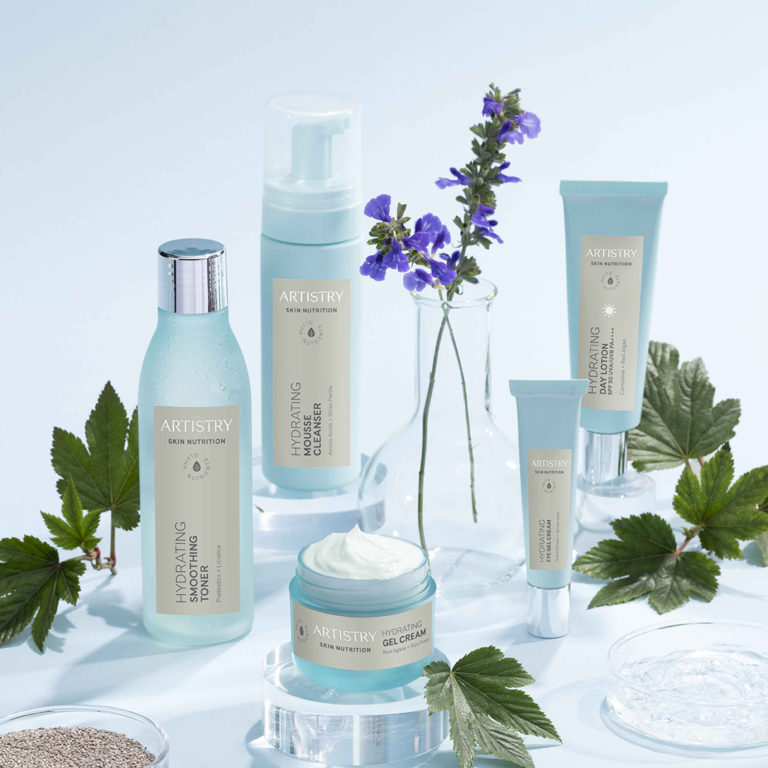 Five bottles of products in the artistry hydrating line on a light blue background