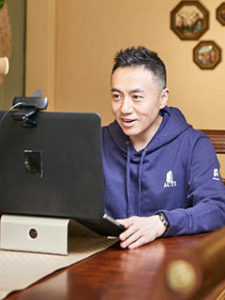 Xiao working on laptop