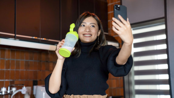 Woman taking a selfie with a shaker bottle