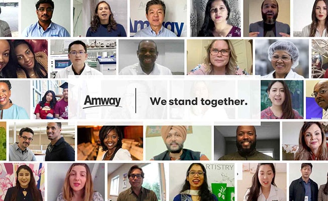Collage of Amway employee head shots with the Amway logo and the text 