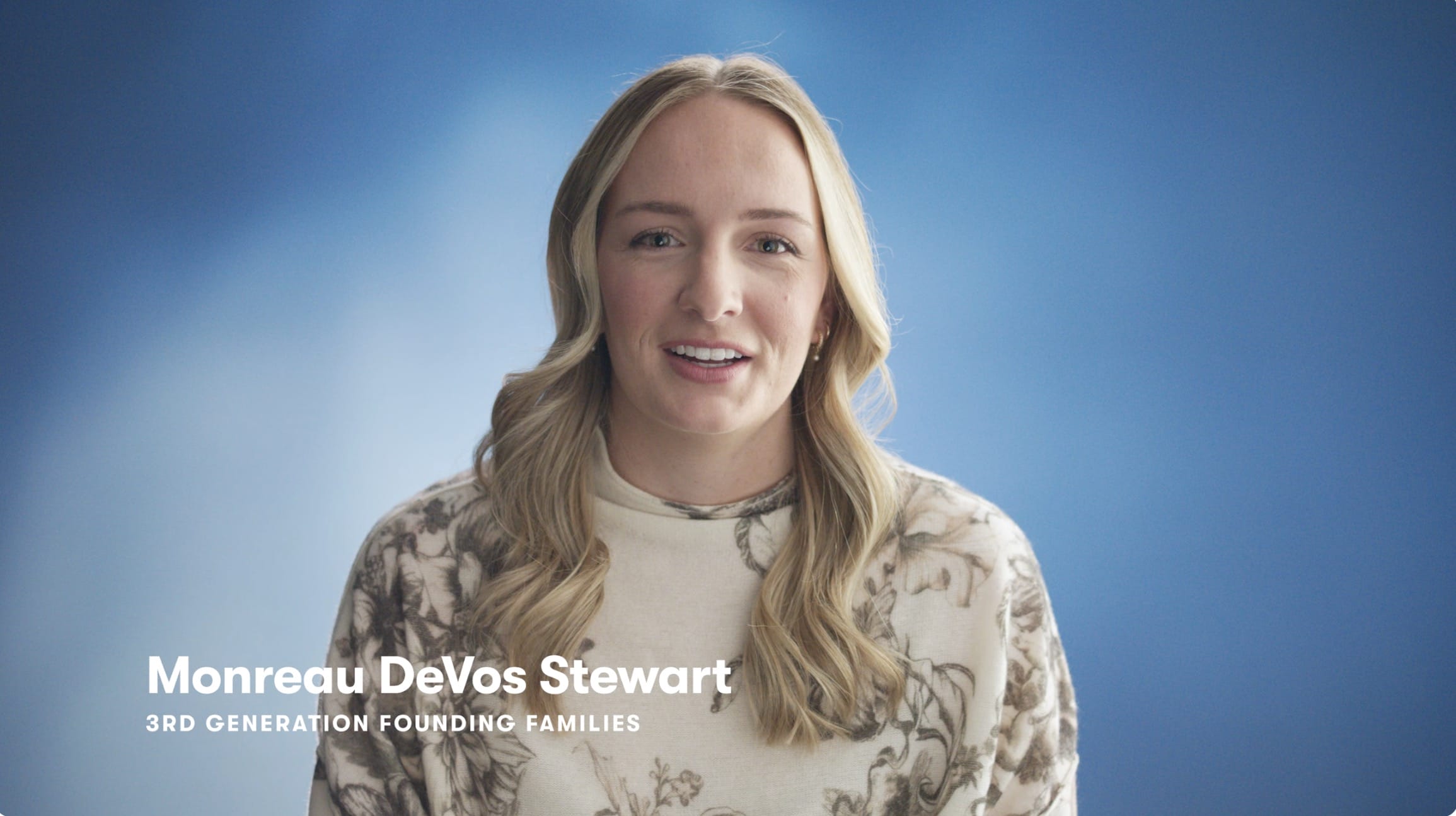 Video thumbnail of Monreau DeVos Stewart wearing a cream sweather with a darker floral pattern. She is sitting in front of a blue background and discussing the freedom an Amway business can offer.