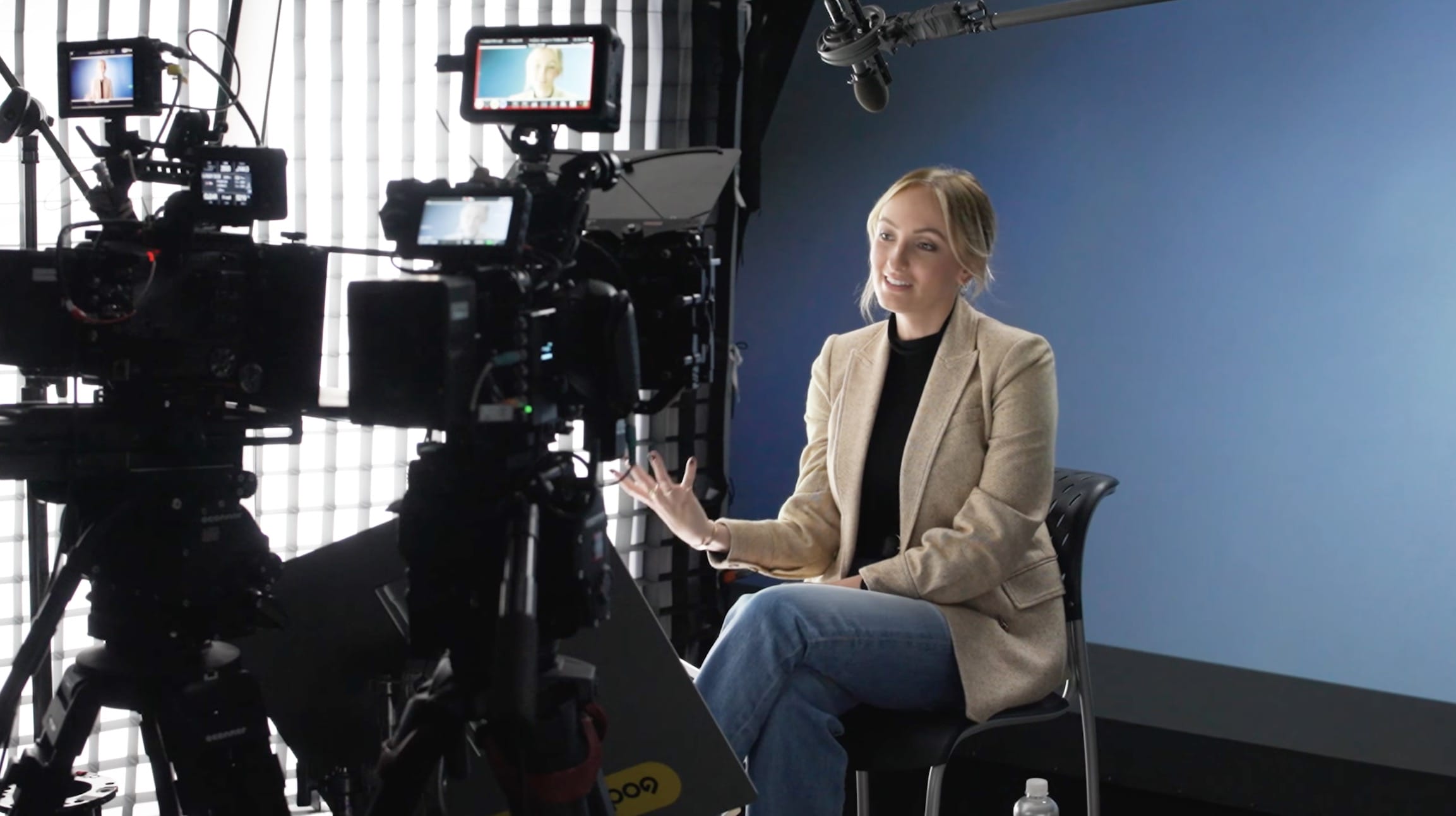 Video thumbnail of Olivia DeVos Griffioen wearing a black shirt and light brown blazer. She is sitting in front of a blue background with two video cameras in the foreground. She is discussing partnership.